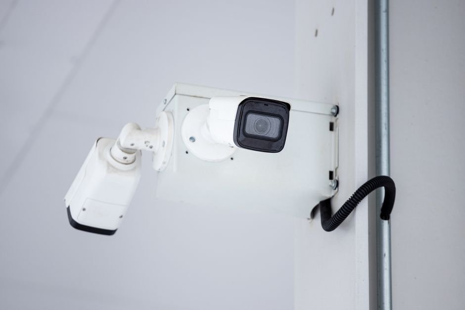 A close-up shot of a modern, mounted surveillance camera highlighting security and surveillance.