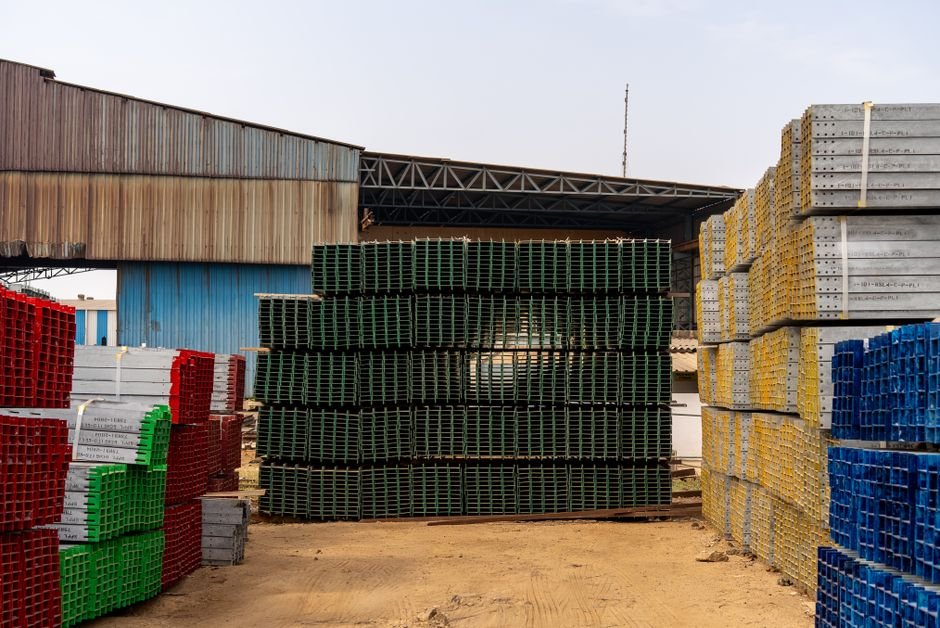 Colorful stacks of industrial materials organized in an outdoor yard, showcasing vibrant organization.
