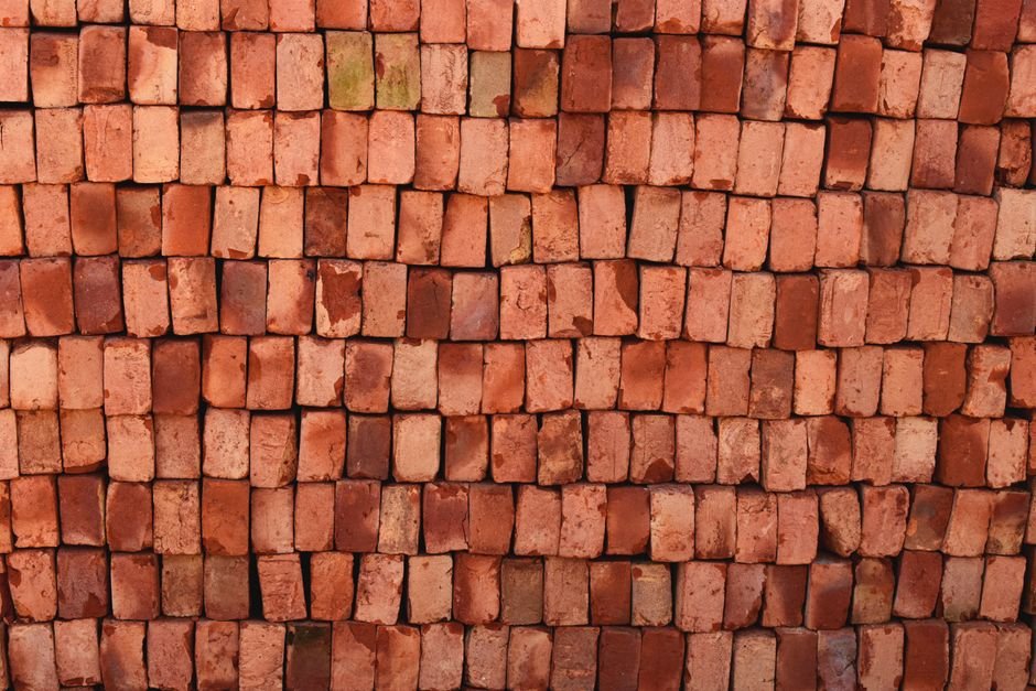 Close-up view of red bricks stacked neatly in Bangladesh, ideal for construction themes.
