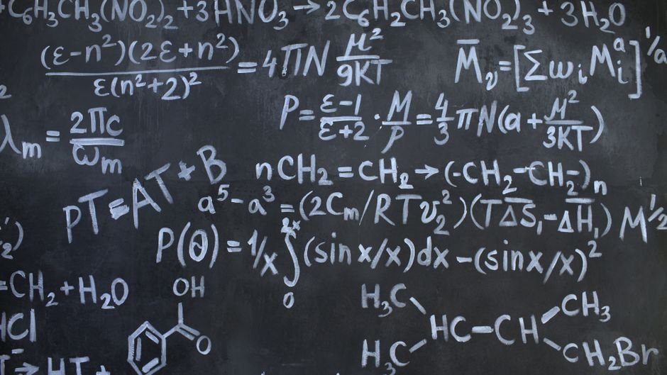 Intricate mathematical and chemical equations chalked on a blackboard symbolizing education and science.
