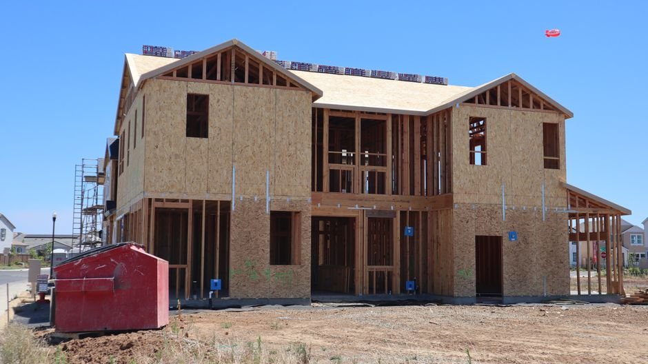 Modern house under construction in Elk Grove, CA, showcasing wooden framing.