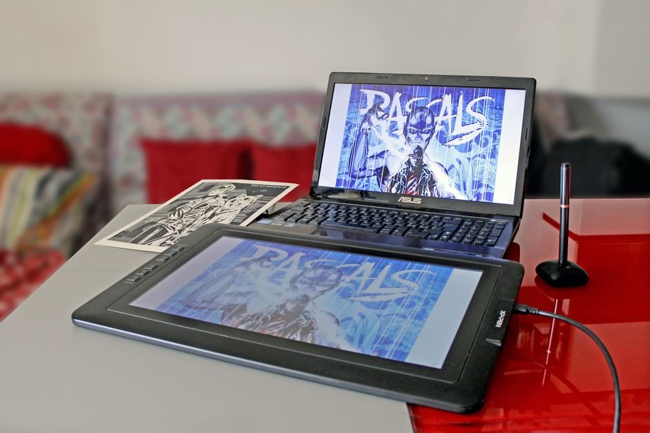 Digital drawing setup with laptop and tablet for modern art creation.