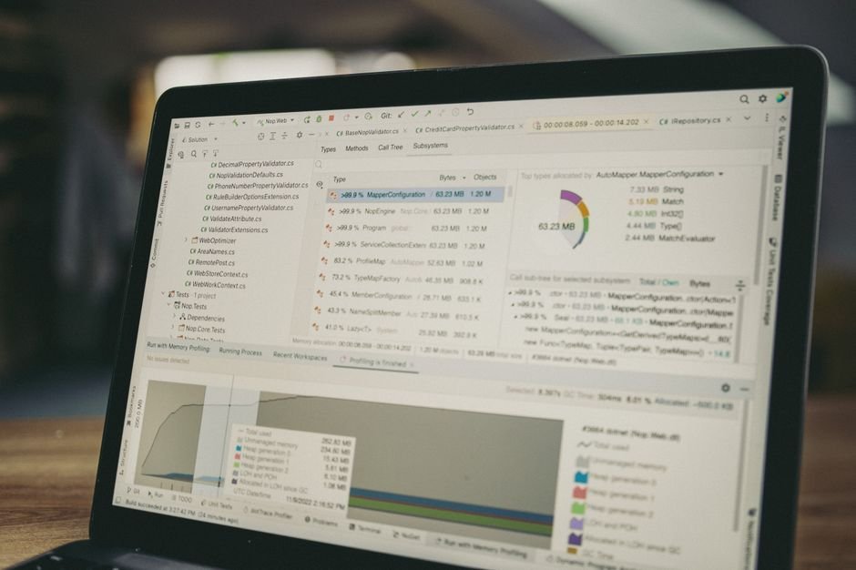 A close-up view of a laptop screen showing a coding and data analysis software interface in an indoor setting.