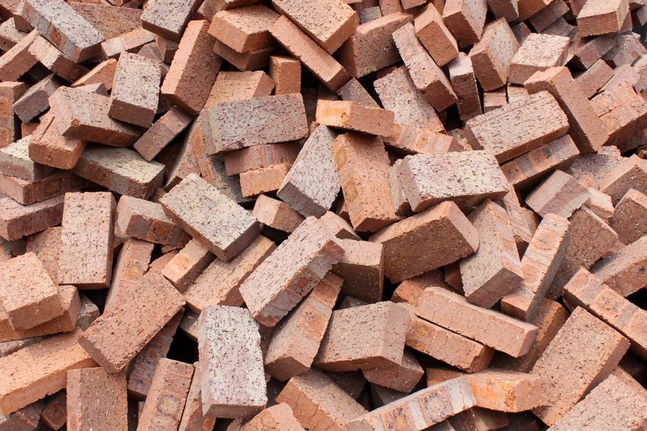A large pile of red bricks suitable for construction and building projects in Indonesia.