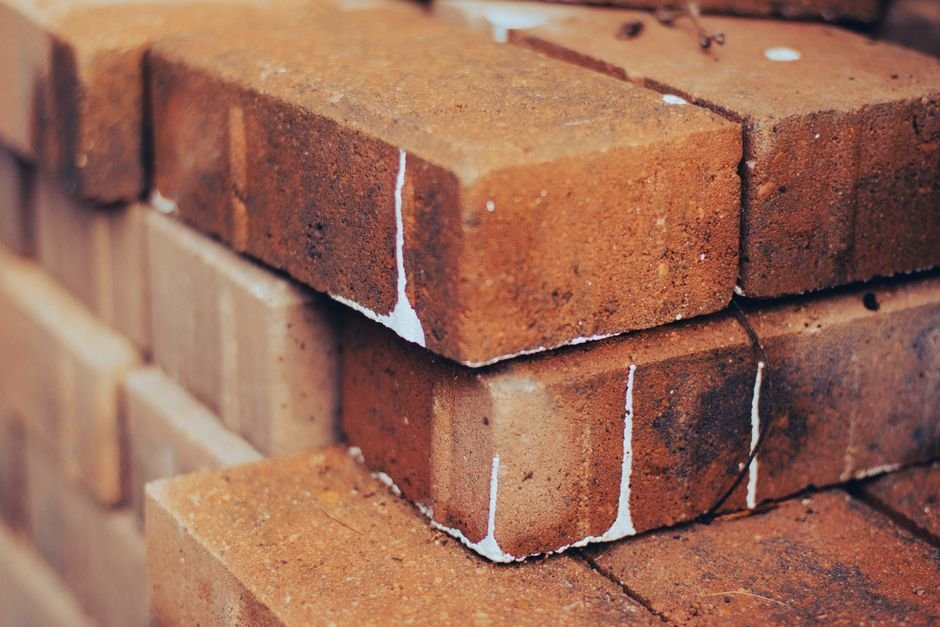Close-up of stacked red bricks showing texture and detail, ideal for building and construction themes.