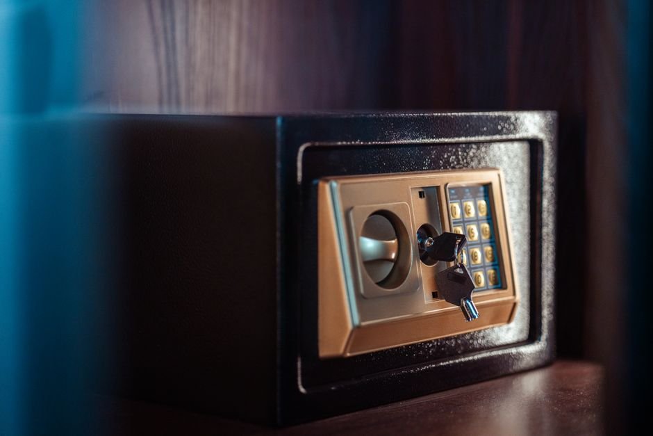 Close-up image of an electronic safe with a key, symbolizing secure protected savings.