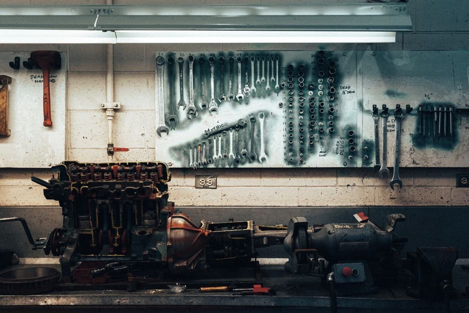 A well-organized workshop scene featuring tools and machinery on a workbench.